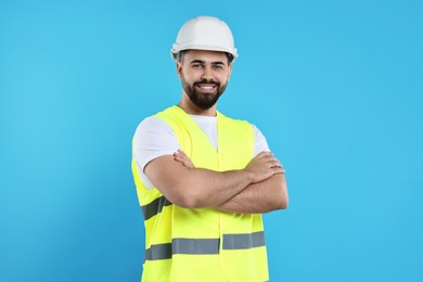 Photo of Engineer in hard hat on light blue background