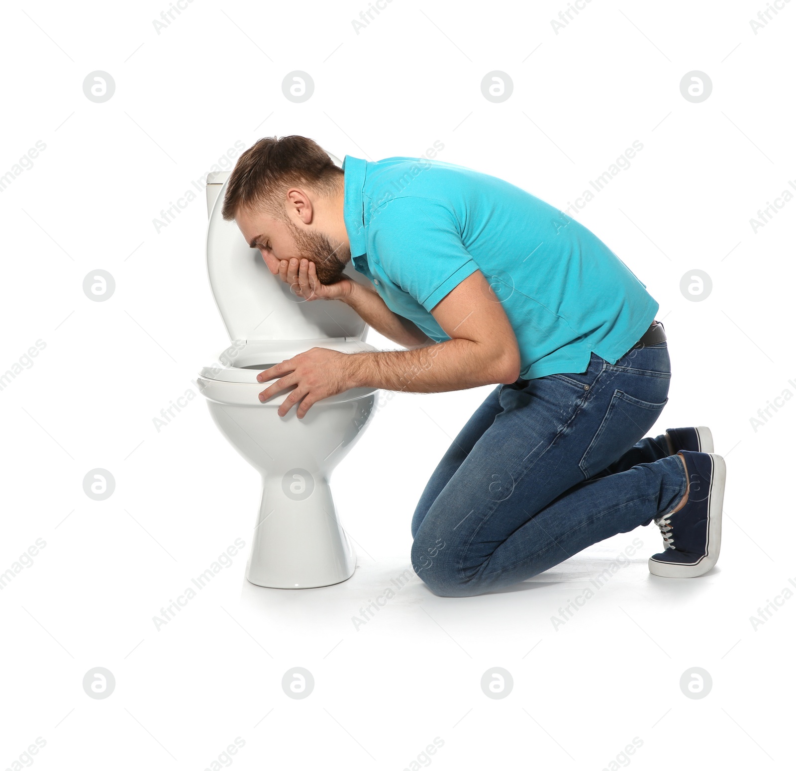 Photo of Young man suffering from nausea near toilet bowl isolated on white