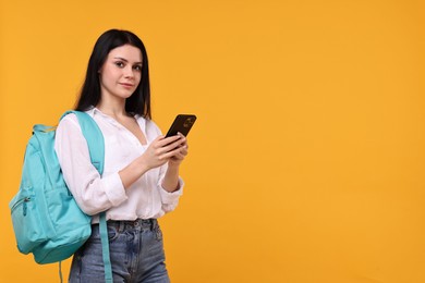 Student with smartphone on yellow background. Space for text