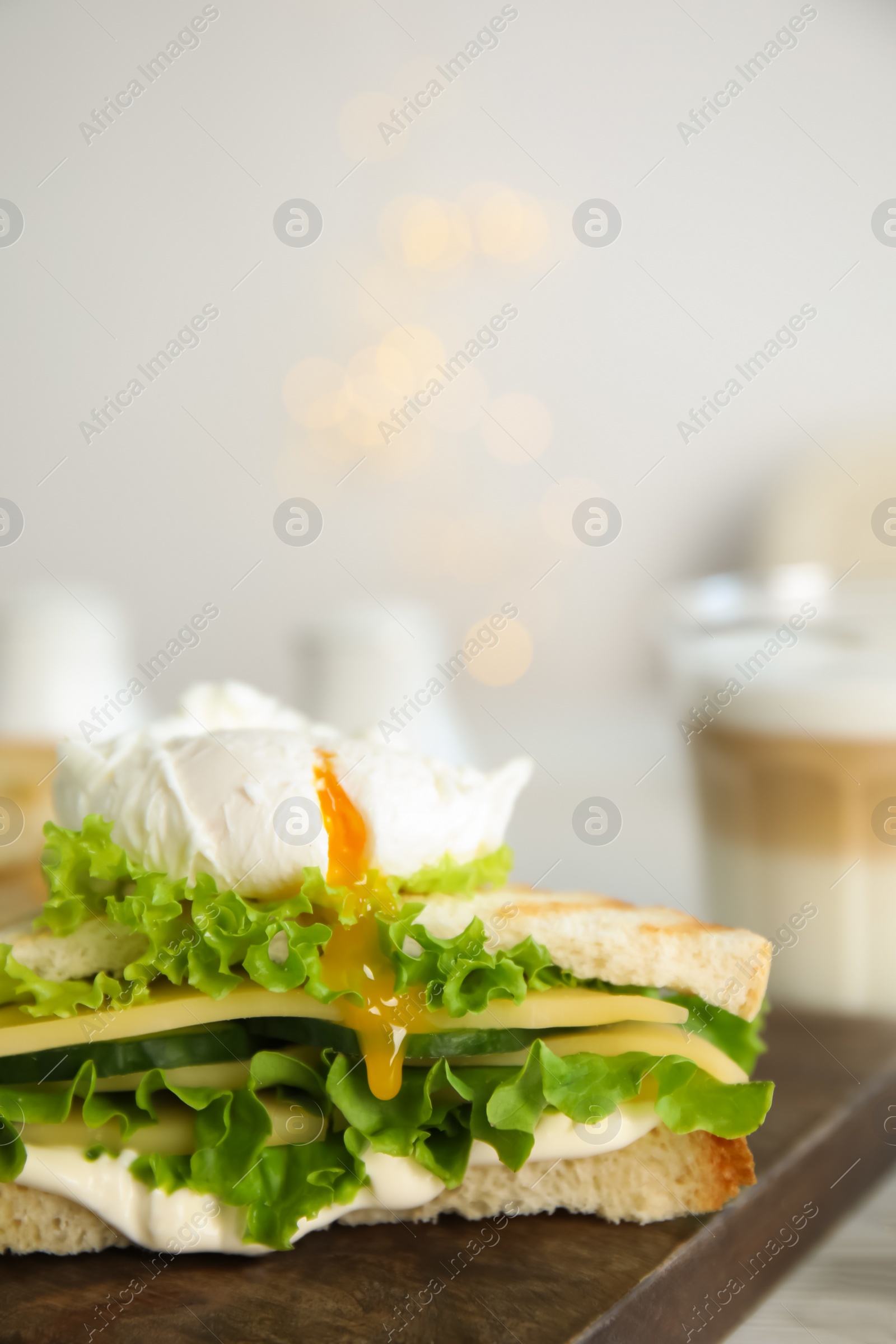 Photo of Delicious sandwich with vegetables and poached egg on board, closeup. Space for text