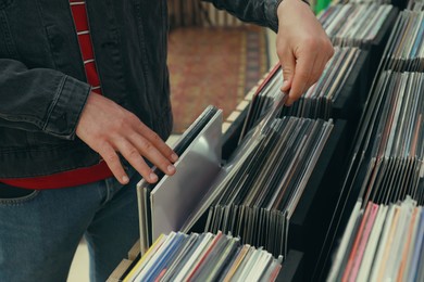 Image of Man choosing vinyl records in store, closeup