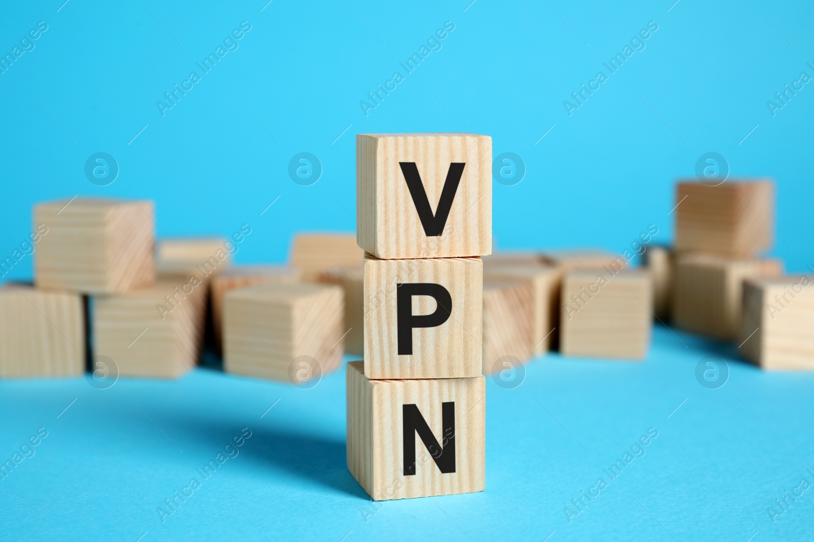 Photo of Wooden cubes with acronym VPN on light blue background