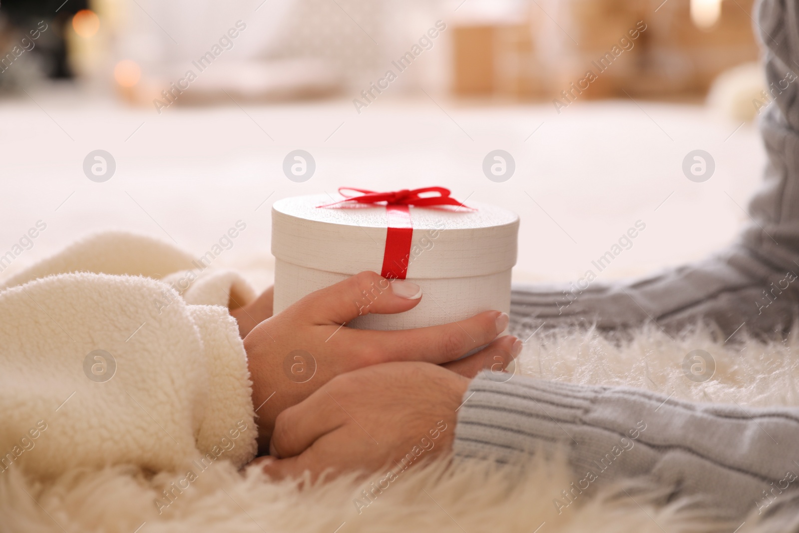 Photo of Couple holding white Christmas gift box, closeup