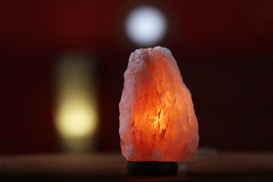 Photo of Himalayan salt lamp on table indoors, space for text