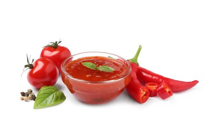 Photo of Spicy chili sauce and ingredients on white background