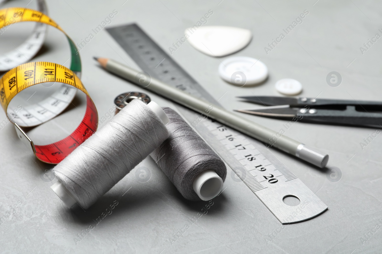 Photo of Composition with accessories for tailoring on table, closeup