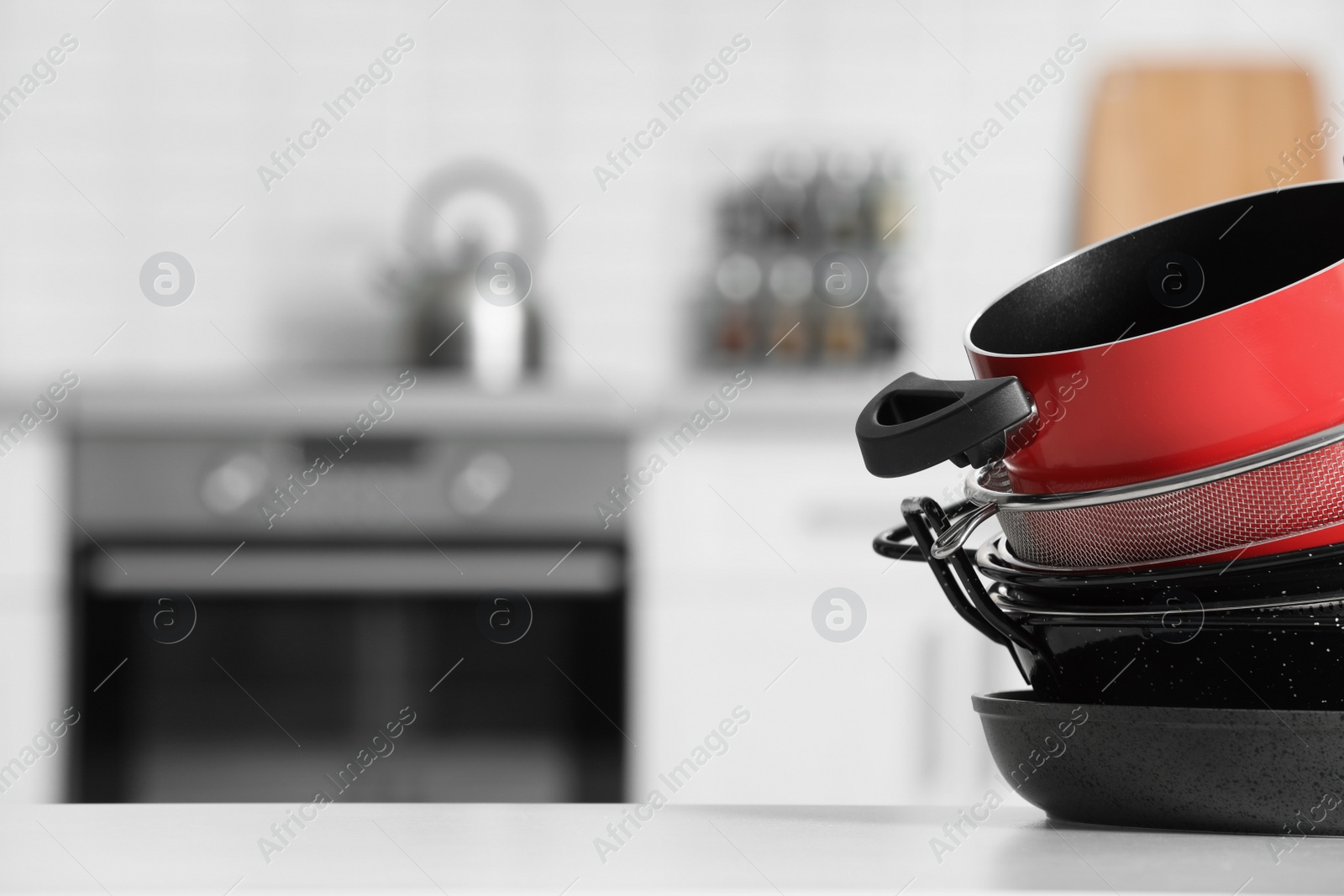 Photo of Set of clean cookware on table in kitchen. Space for text