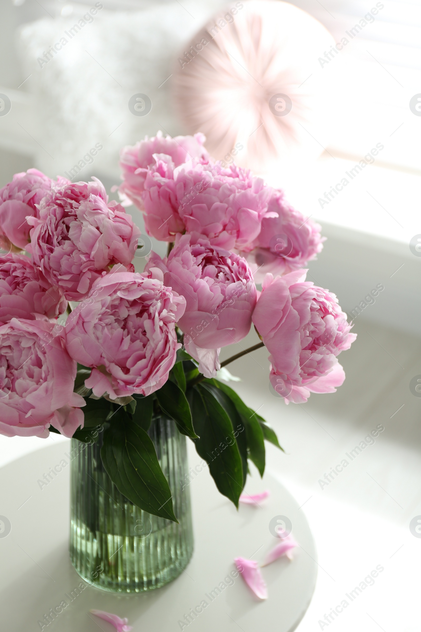 Photo of Bouquet of beautiful peonies on table indoors