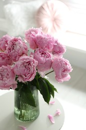 Photo of Bouquet of beautiful peonies on table indoors