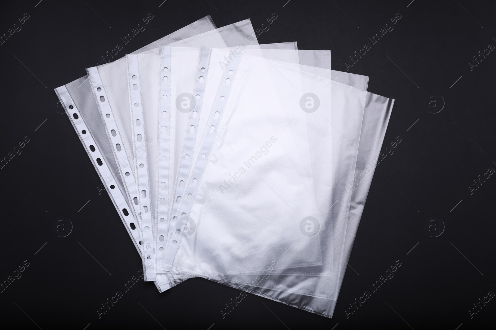 Photo of Punched pockets on black background, flat lay