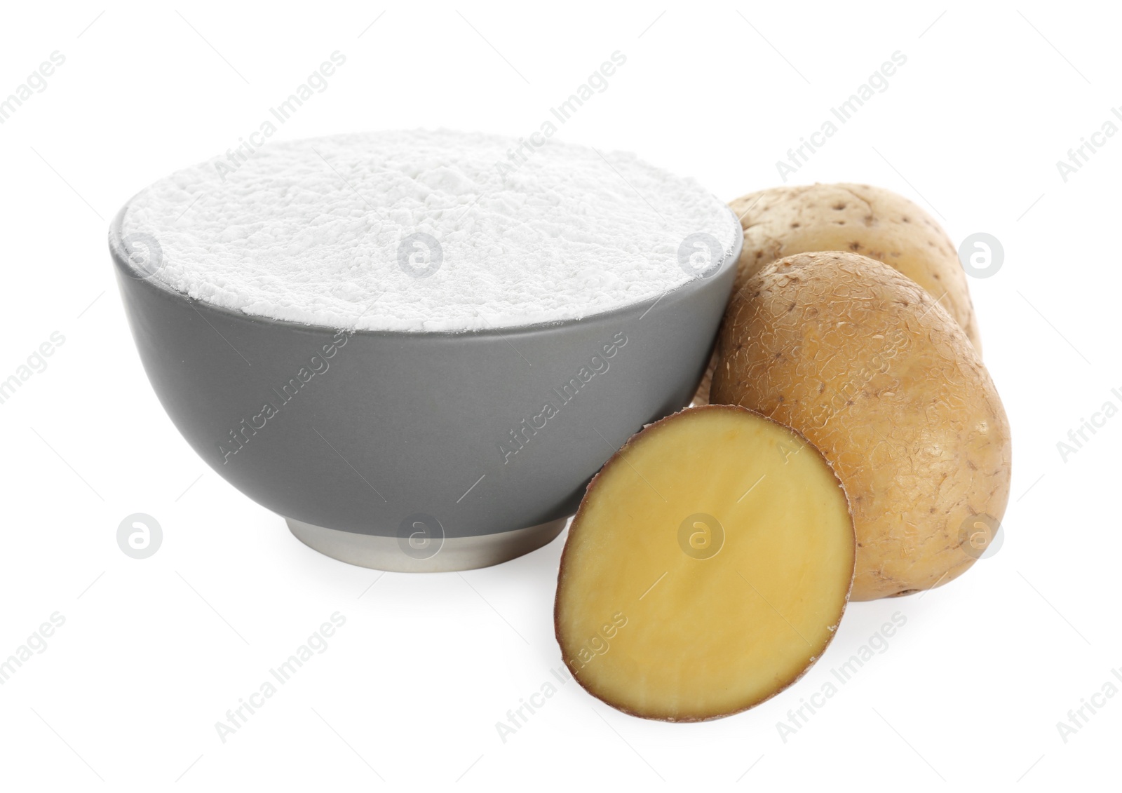 Photo of Bowl with starch and fresh potatoes on white background