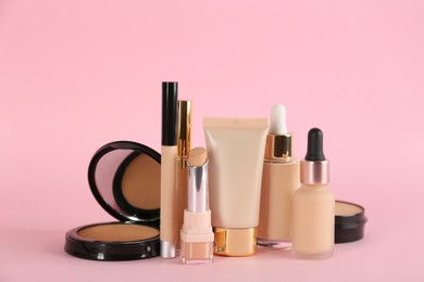 Photo of Foundation makeup products on pink background. Decorative cosmetics
