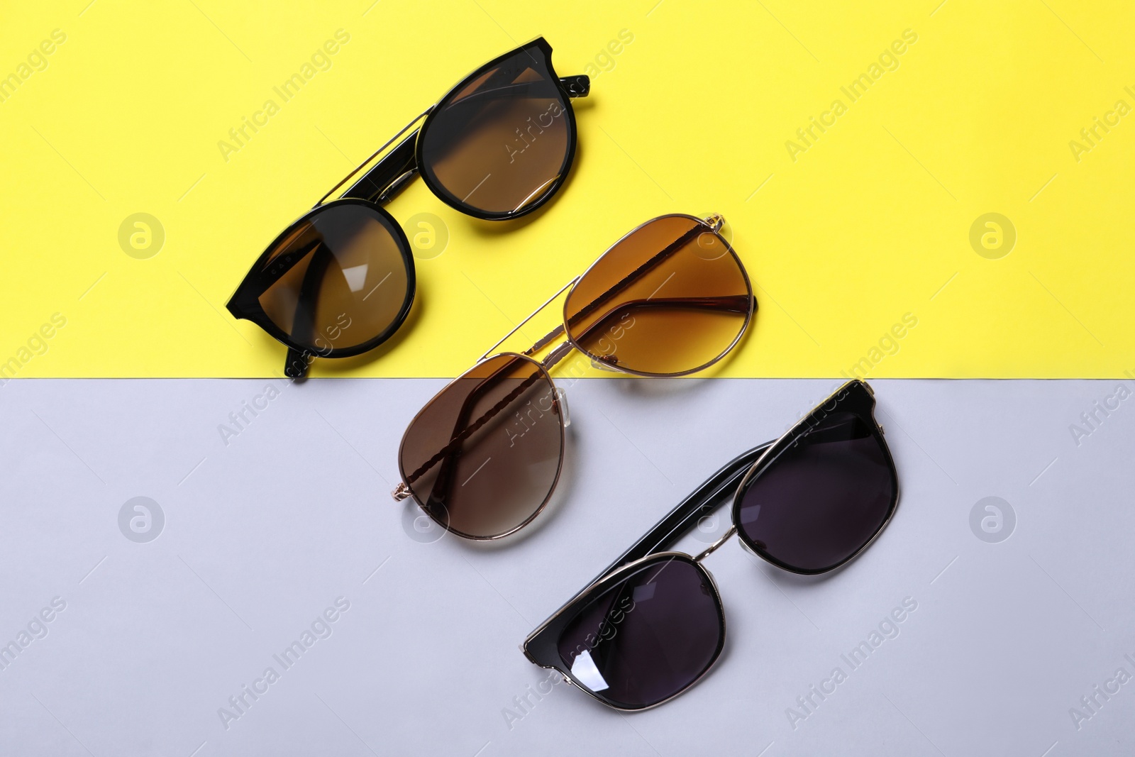 Photo of Stylish sunglasses on color background, flat lay