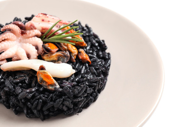 Delicious black risotto with seafood in plate, closeup