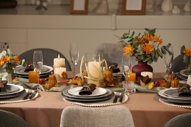 Photo of Table set with beautiful autumn decor for festive dinner in room