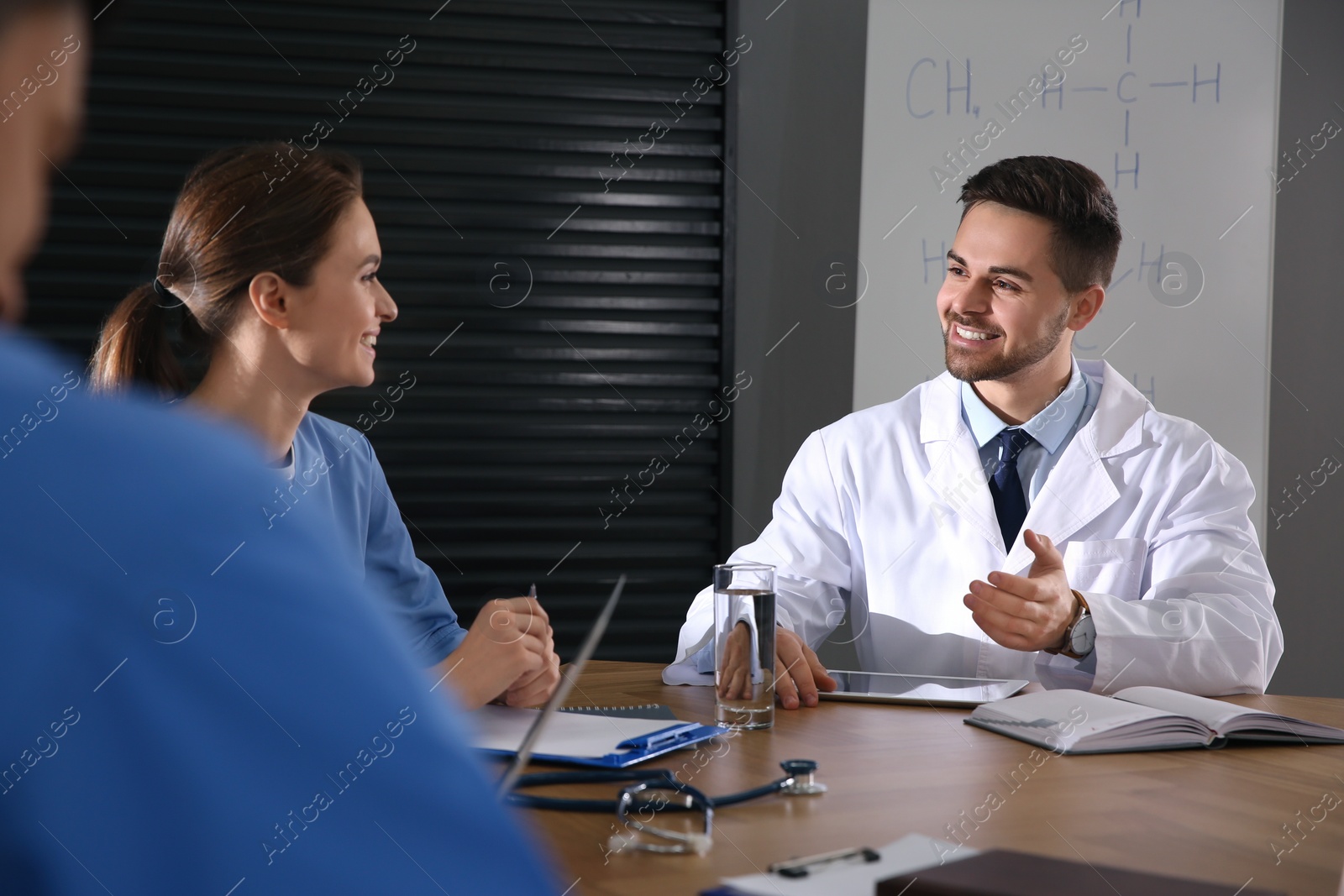 Photo of Team of professional doctors having meeting in office