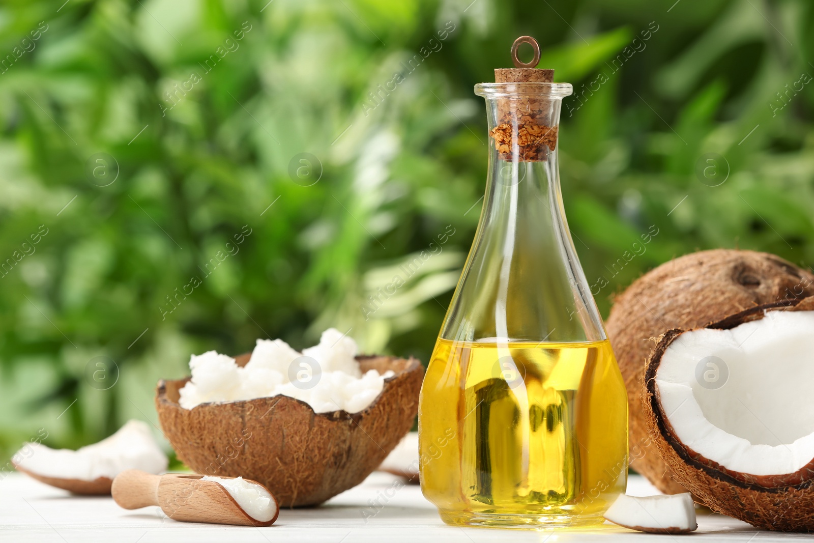 Photo of Composition with coconut oil on table against blurred background. Healthy cooking