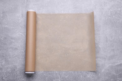 Photo of Roll of baking paper on light grey table, top view