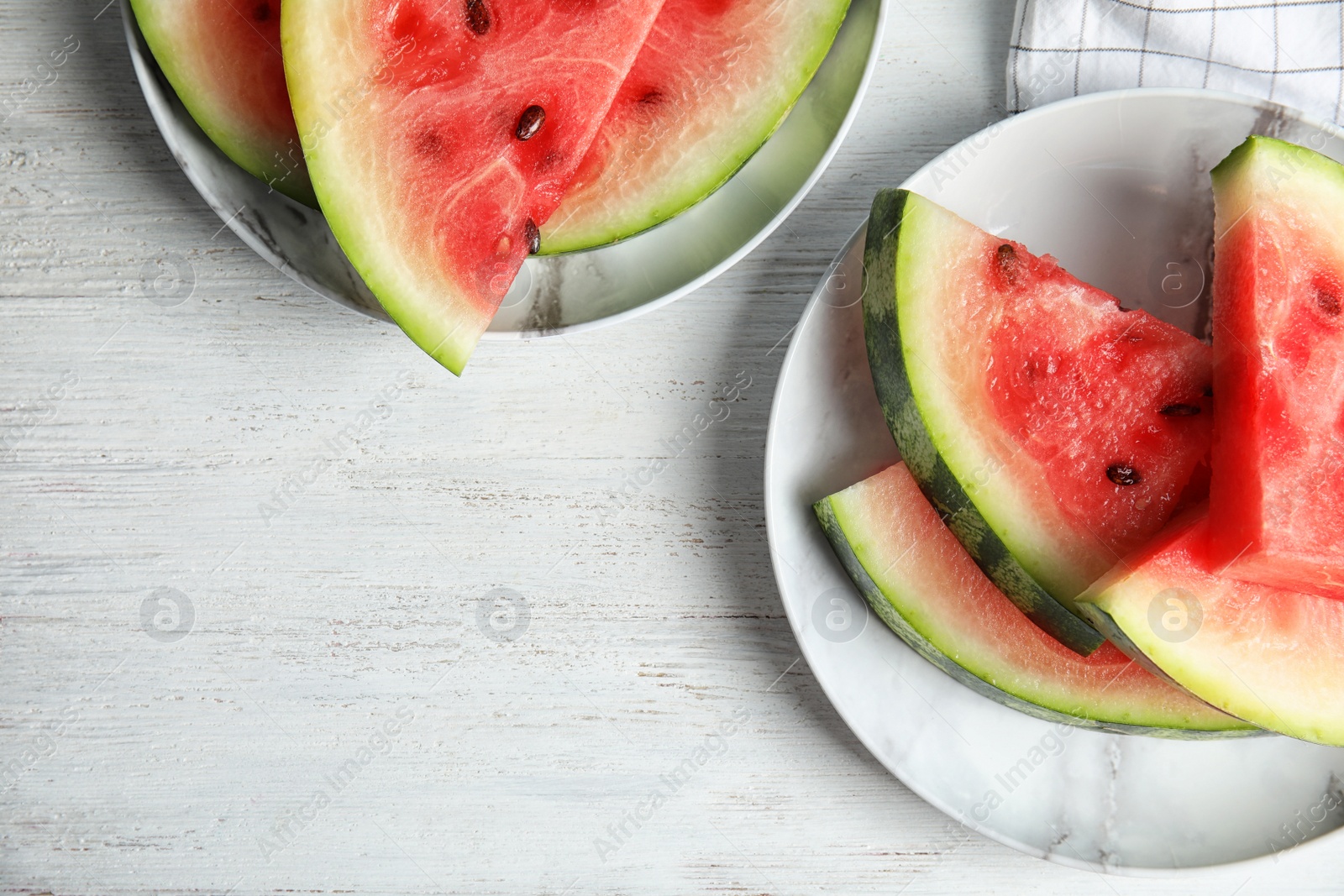 Photo of Flat lay composition with watermelon slices on white wooden background