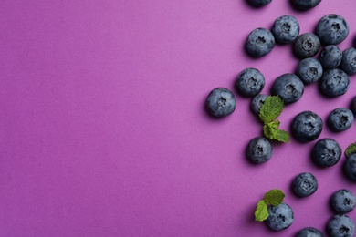 Photo of Flat lay composition with tasty blueberry and space for text on color background