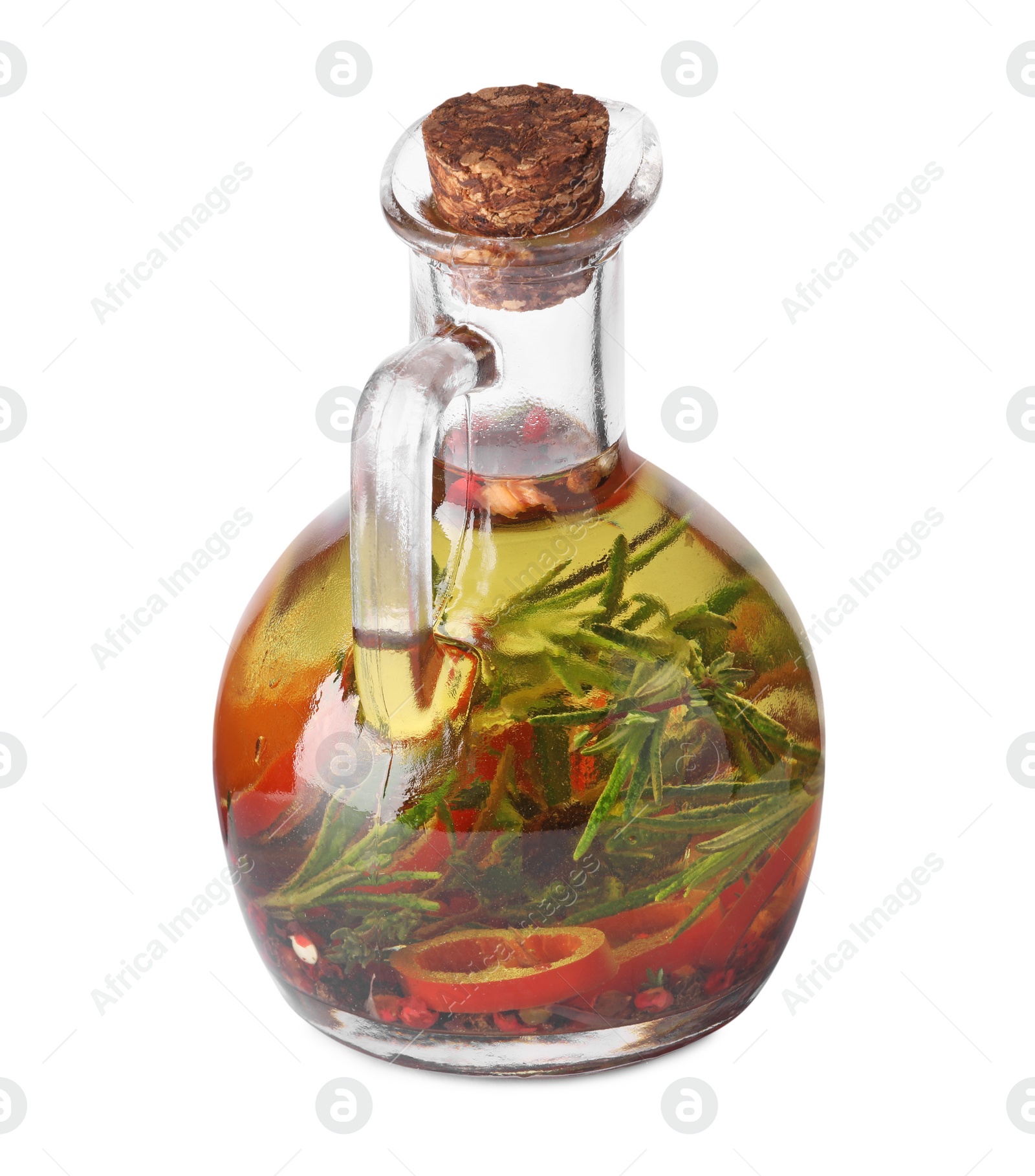 Photo of Glass jug of cooking oil with spices and herbs isolated on white