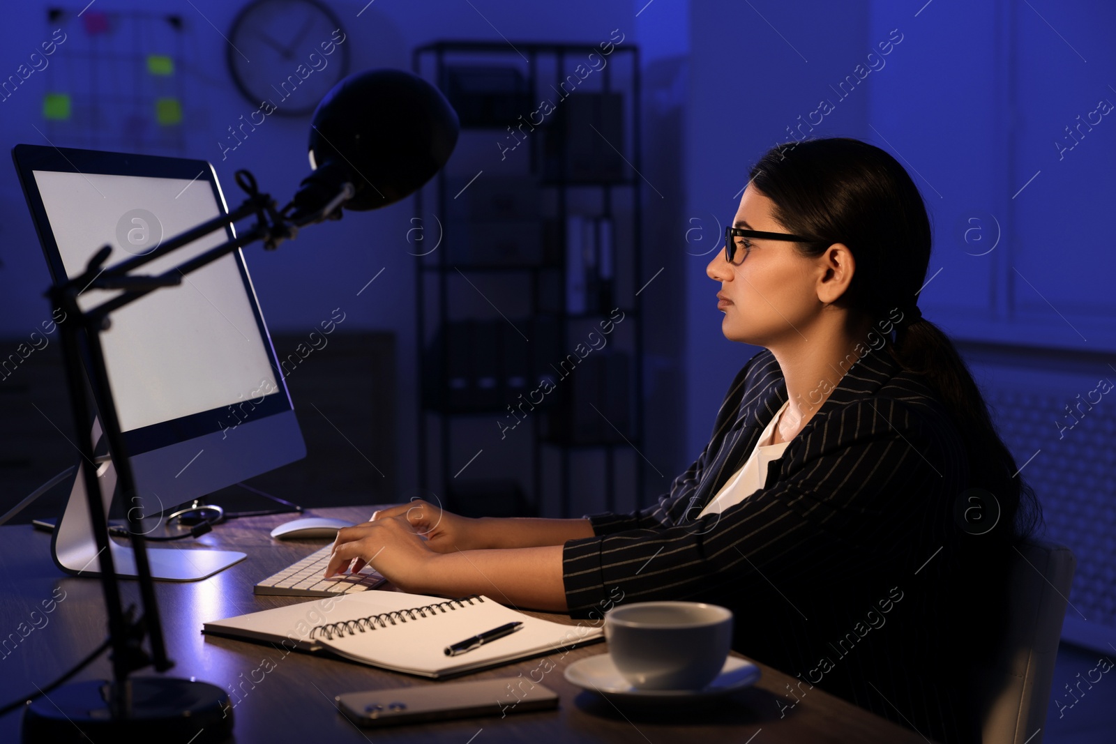 Photo of Tired businesswoman working at night in office