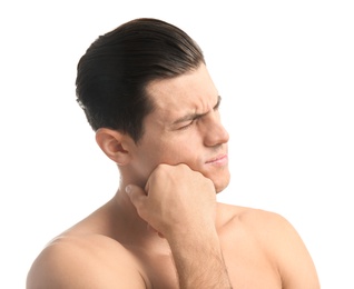 Young man suffering from toothache on white background