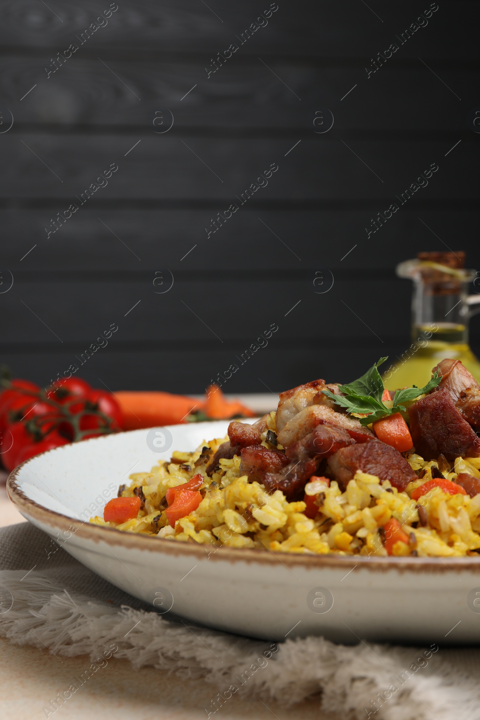 Photo of Delicious pilaf with meat and carrot on table, closeup. Space for text