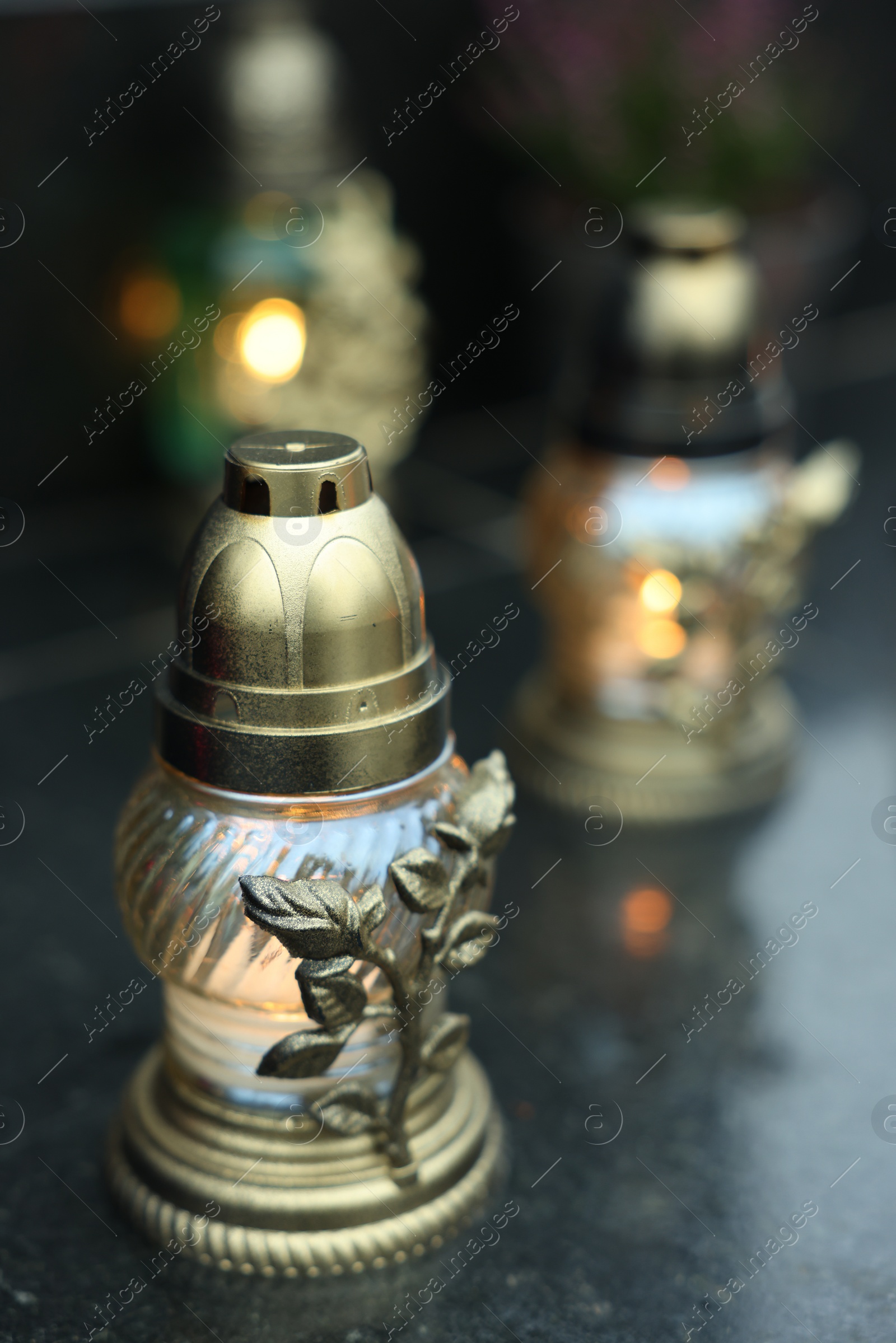 Photo of Grave lights on granite surface at cemetery