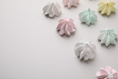 Photo of Delicious meringue cookies on light background, closeup. Space for text