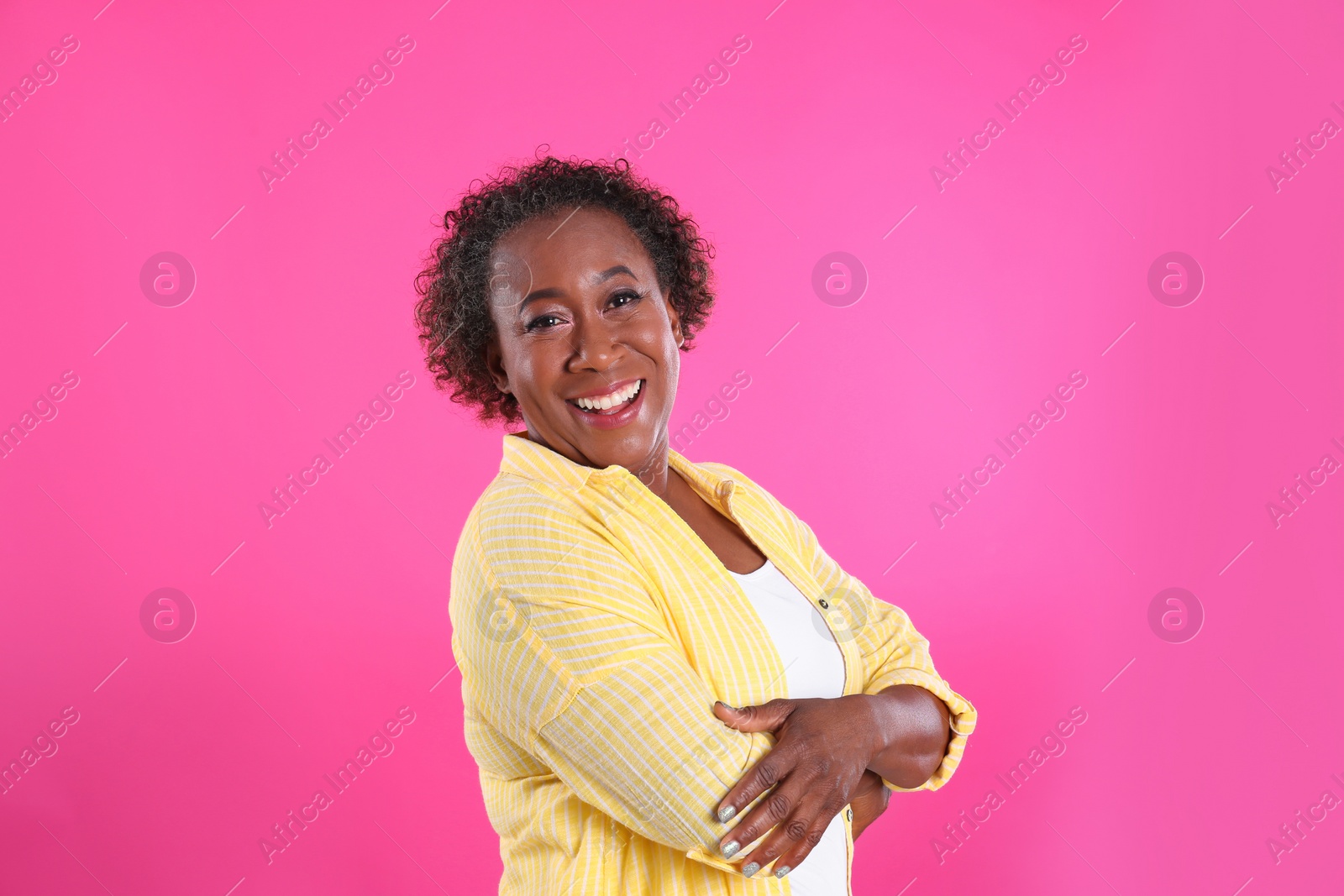 Photo of Portrait of happy African-American woman on pink background