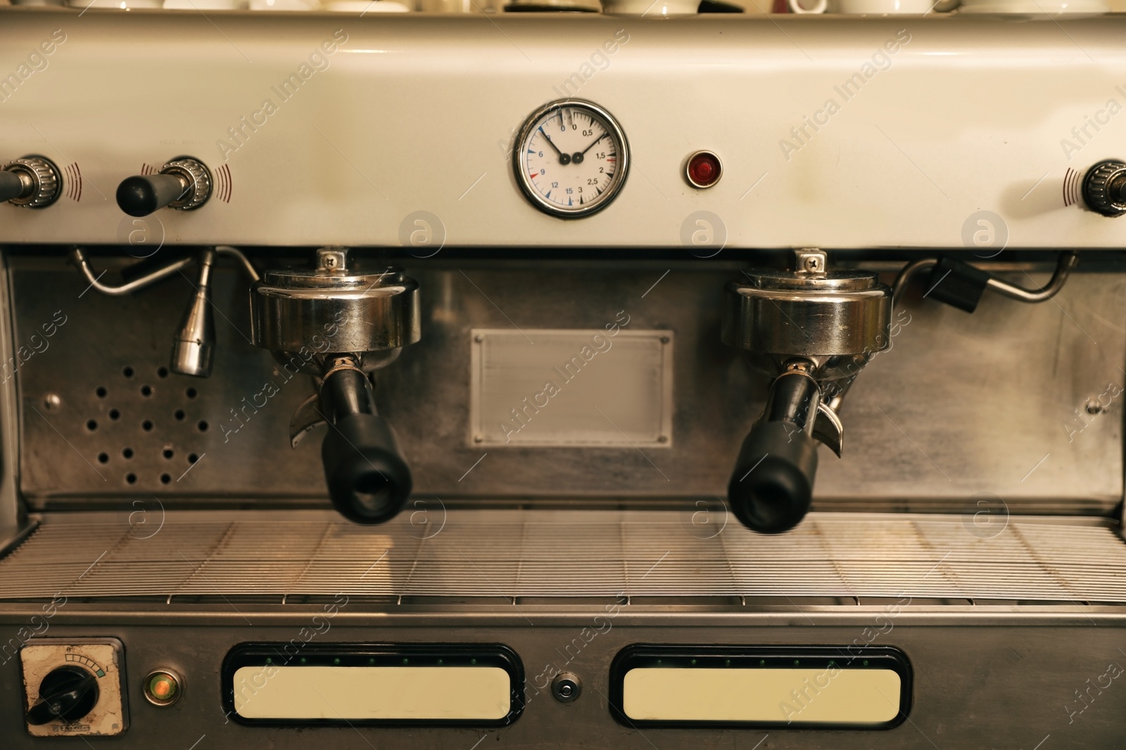 Photo of Modern electric coffee machine with portafilters, closeup