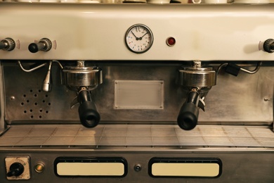 Modern electric coffee machine with portafilters, closeup