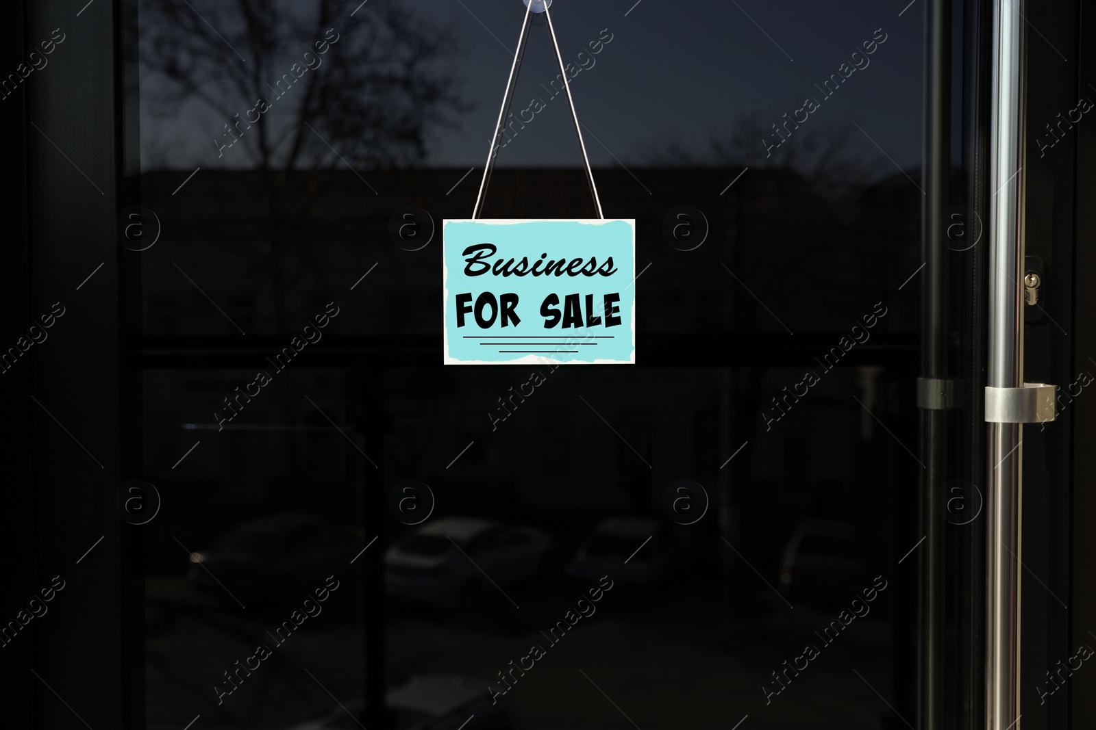 Image of Light blue sign with Business For Sale hanging on glass door