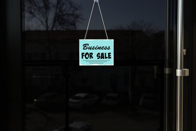 Image of Light blue sign with Business For Sale hanging on glass door