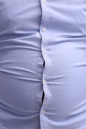 Man wearing tight shirt, closeup view. Overweight problem