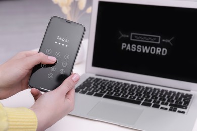 Photo of Woman unlocking smartphone with blocked screen near laptop indoors, closeup