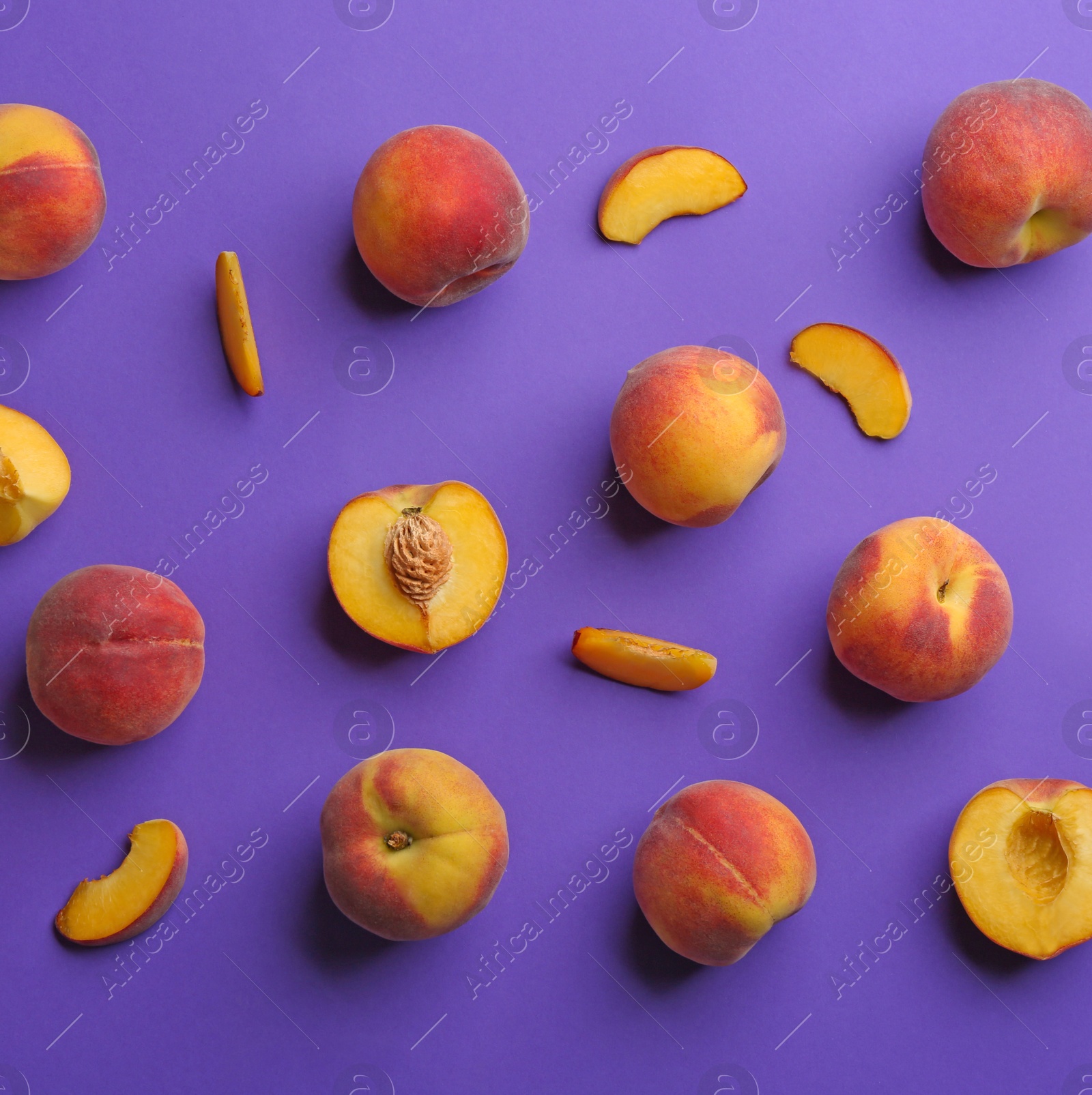 Photo of Flat lay composition with fresh peaches on purple background