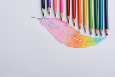 Photo of Drawing of feather and colorful pencils on white background, top view