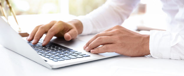 Image of Man working on computer at table in office, closeup. Banner design