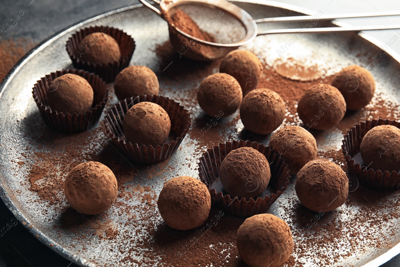 Photo of Plate with tasty chocolate truffles on table