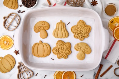 Photo of Tasty cookies and cutters on white table, flat lay