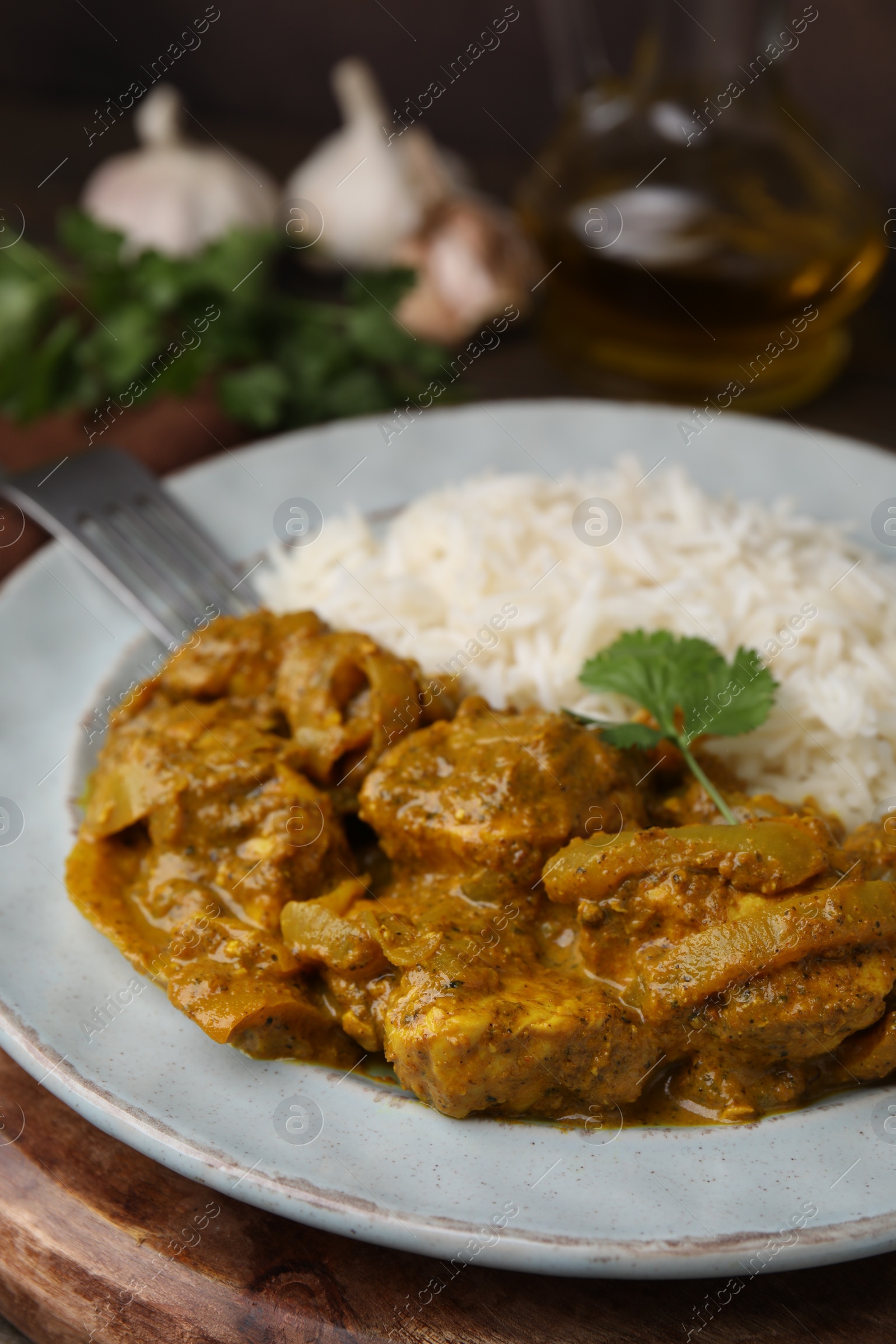 Photo of Delicious chicken curry with rice on table, closeup