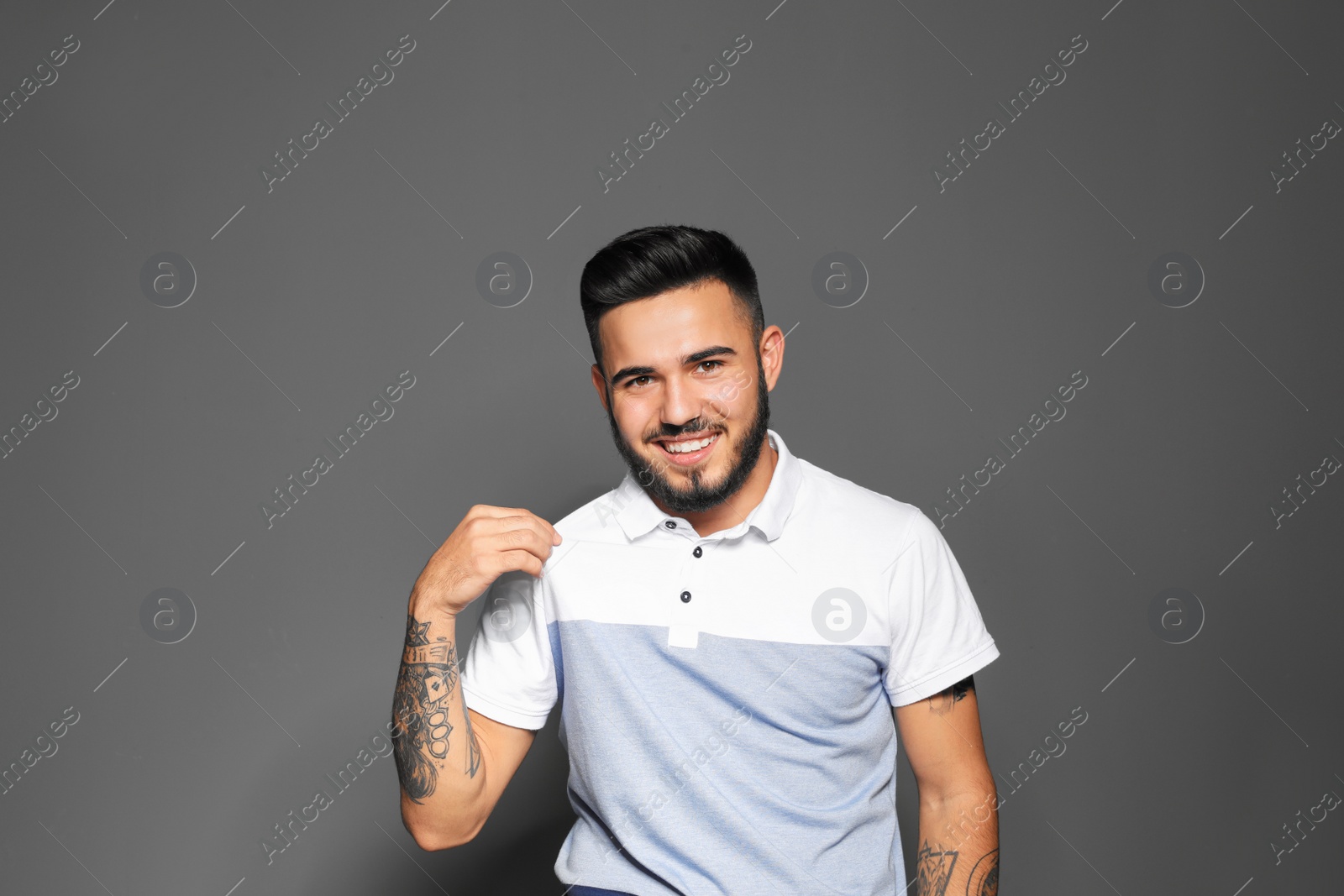 Photo of Portrait of handsome young man on gray background