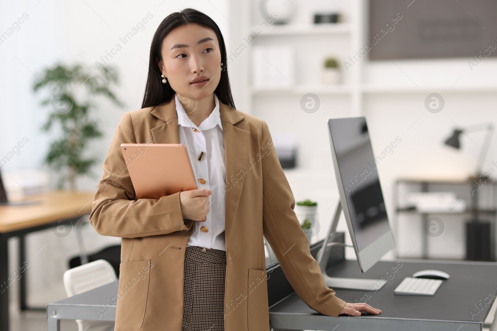 Photo of Portrait of beautiful businesswoman with tablet in office. Space for text