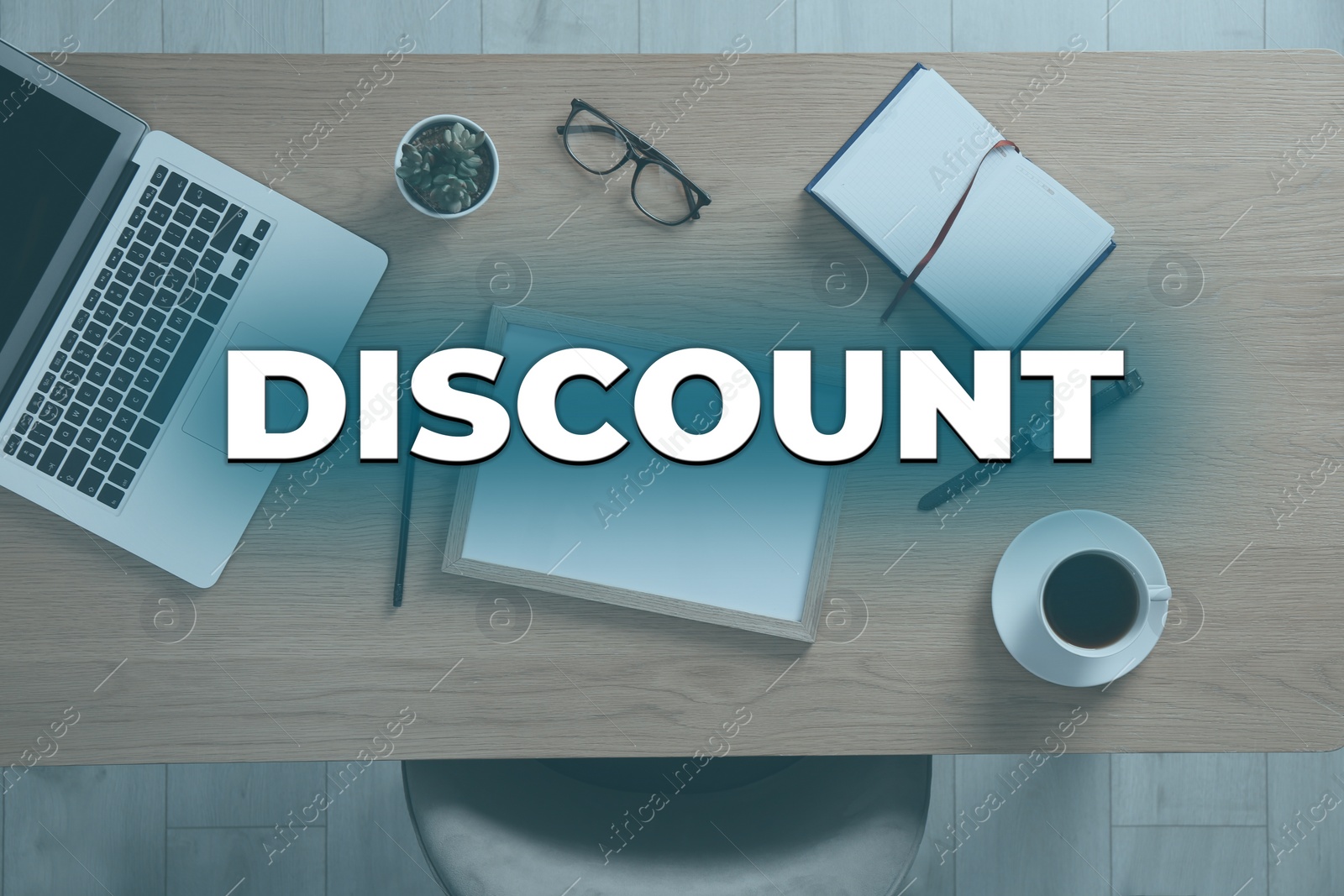 Image of Discount concept. Wooden table with laptop, cup of coffee and stationery indoors, top view