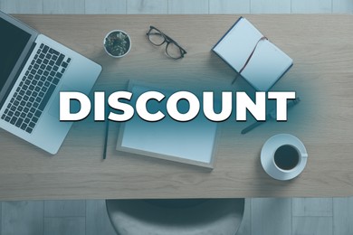 Image of Discount concept. Wooden table with laptop, cup of coffee and stationery indoors, top view