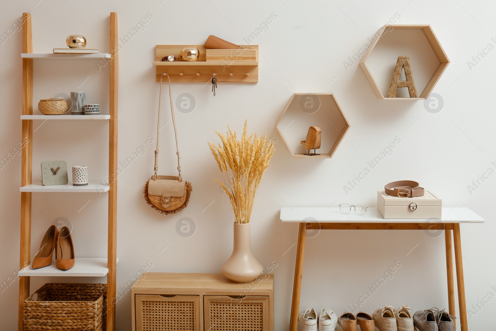 Photo of Stylish hanger for keys on white wall in hallway