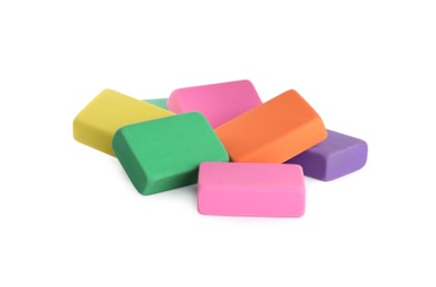 Photo of Pile of bright erasers on white background