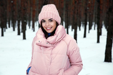 Young woman posing in snowy winter forest